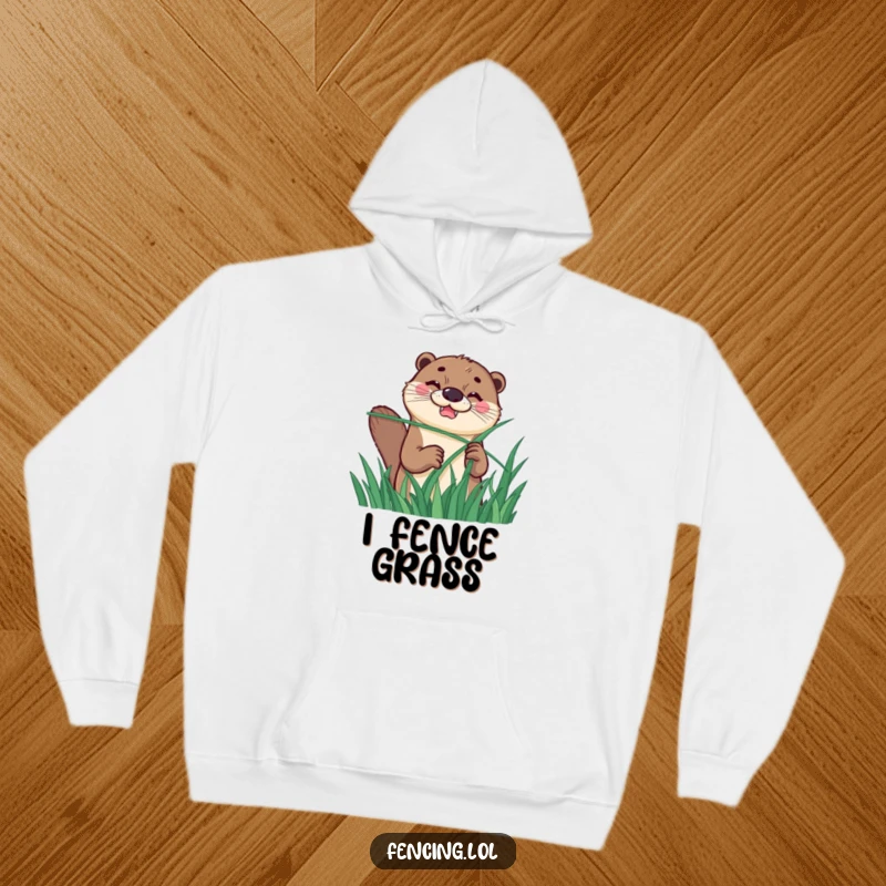 Funny hoodie depicting a happy otter with a determined grin, humorously fencing with a long blade of grass for a witty look.
